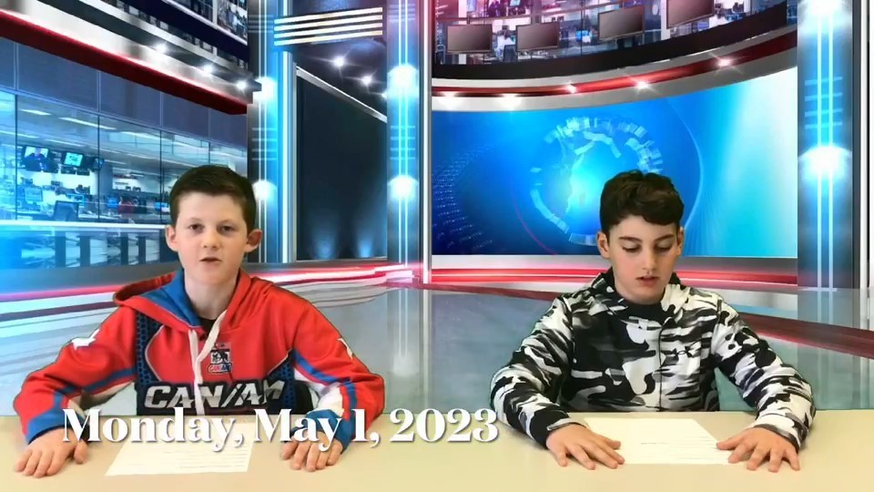Students reading with official news room background.