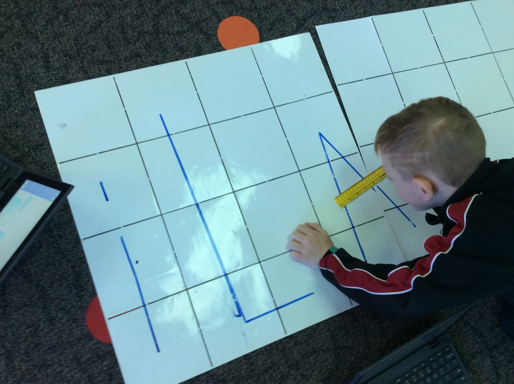 Alden uses a ruler to determine that the cross line in the "A" is less than a 16cm step.