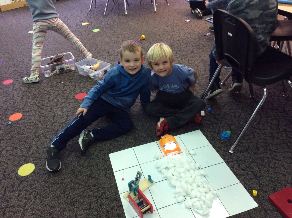 These boys coded Bee-Bot to push the "snow".